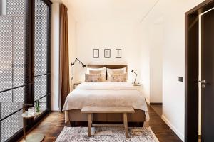 a bedroom with a large bed and a table at The Weinmeister Berlin-Mitte - Adults Only in Berlin