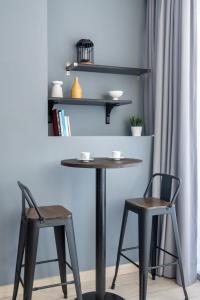 uma mesa e duas cadeiras e uma mesa e prateleiras em Silkhaus comfy furnished studio in the heart of DIFC em Dubai