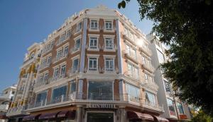 a tall brick building with a balcony at Paris Hotel Châu Đốc in Chau Doc