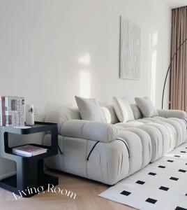 a white couch in a living room with a table at The Beacon Executive @Penang Georgetown in George Town