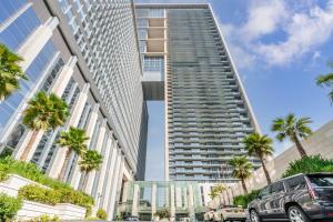 a tall building with palm trees in front of it at Silkhaus elegant studio with Burj Khalifa view and balcony in Dubai