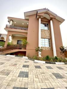 a large building with a courtyard in front of it at Hotel Fountain Blu in Abeokuta