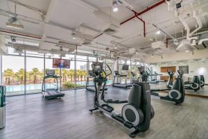 a gym with treadmills and elliptical machines at Silkhaus modern studio with Burj Khalifa view in DIFC in Dubai