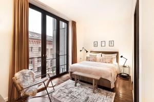a bedroom with a bed and a large window at The Weinmeister Berlin-Mitte - Adults Only in Berlin