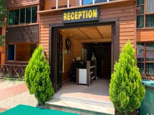 an entrance to a building with a sign that reads reception at Bavul Suite in Uzungöl
