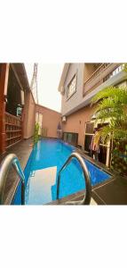 a swimming pool in front of a house at Hotel Fountain Blu in Abeokuta