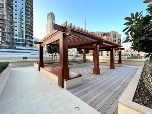 a wooden pavilion on the roof of a building at Silkhaus Burj Khalifa view large 2BDR in new tower in Dubai