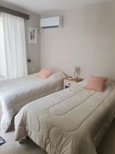 two beds sitting next to each other in a room at MANDALA HOME in Durazno