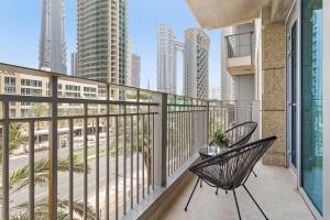 d'un balcon avec deux chaises et vue sur la ville. dans l'établissement Silkhaus work from home friendly 1BDR in Downtown, à Dubaï