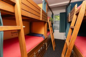 a room with two bunk beds in a dorm room at Haka Lodge Auckland in Auckland