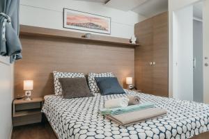 a bedroom with a large bed with two pillows at San Antonio mobile homes in Biograd na Moru
