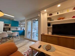 a living room with a large flat screen tv at Itsasoa by Basque Homes in Donostia-San Sebastián