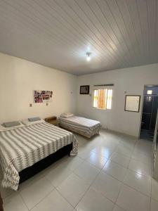 a bedroom with two beds in a room at Chalé de Praia - Salinopolis/Pa in Salinópolis