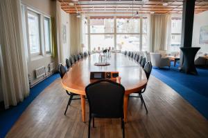 a conference room with a large wooden table and chairs at Quality Hotel Sundsvall in Sundsvall