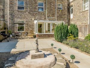 a statue in front of a brick building at 2 bed in Tintern 89323 in Tintern