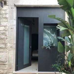 a black door with two windows in a building at Locus Pendinelli Trani in Trani