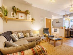 a living room with a couch and a table and a kitchen at 2 Bed in Westward Ho 89540 in Bideford