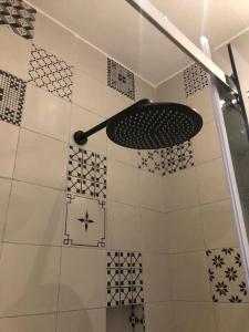 a bathroom with a shower with a black at Locus Pendinelli Trani in Trani