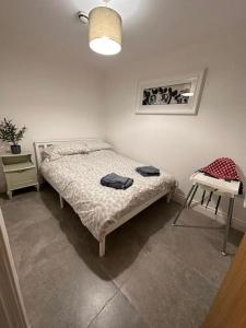 a bedroom with a bed and a table and a chair at Boutique Style Apartment Belfast in Belfast