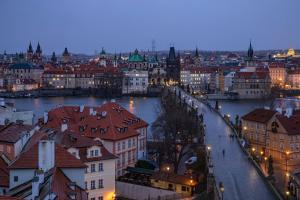 a city at night with a river and buildings at Castle Proximity Suite by Rentez in Prague
