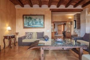 a living room with a couch and a table at Casa en Cala Vadella con piscina y vistas al mar in Sant Josep de sa Talaia