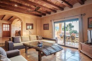 a living room with a couch and a table at Casa en Cala Vadella con piscina y vistas al mar in Sant Josep de sa Talaia
