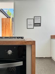 a kitchen with a stove and some pictures on the wall at La Puerta Amarilla in Mendoza