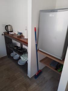 a kitchen with a mop next to a refrigerator at 356 Apartments - in Mendoza