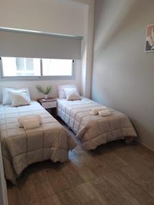 um quarto com 2 camas e uma janela em 356 Apartments - em Mendoza