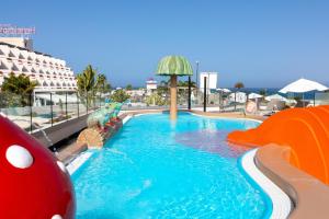 a swimming pool in a resort with a water slide at Alexandre Hotel Gala in Playa de las Americas