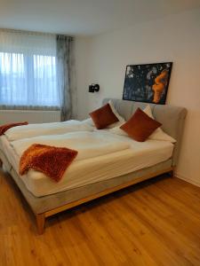 a large bed with pillows on it in a room at Gästezimmer / Weingut Peter in Wachenheim an der Weinstraße