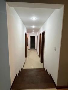 a hallway of a building with white walls and a hallway at Reserva 69 Hostel in Sao Paulo