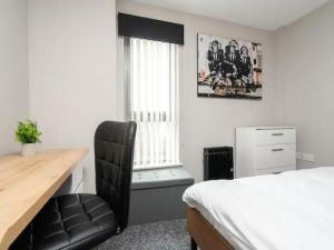 a bedroom with a desk and a bed and a chair at Pass the Keys Unique Central Liverpool Penthouse in Liverpool