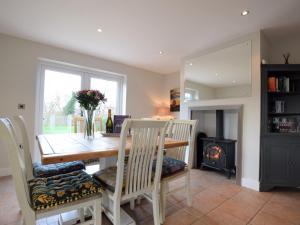 a dining room with a table and a fireplace at 3 bed in York HH015 in Tockwith