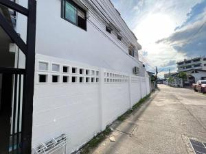 a white fence on the side of a building at 52PrivateHouse in Lampang