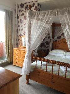 1 dormitorio con cama de madera y dosel en Royal Hotel, en Blackpool