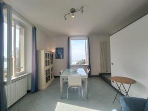 a dining room with a table and a window at MISTRAL House in Levanto