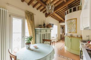 a kitchen with a table and a dining room at The Perfect Place in Ravenna