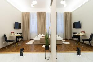 a living room with two beds and two tables at Jacuzzi Berka Apartamenty in Krakow
