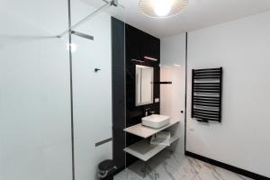 a bathroom with a sink and a mirror at MODERNO hotel Garwolin 