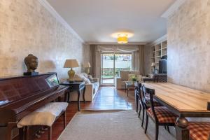 a living room with a table and a piano at Arkotxa apartment by People Rentals in Getxo