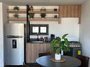 a kitchen with a table and a refrigerator at Céntrico, muy cómodo y agradable. Con gran vista in Tijuana +8 photos