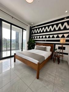 um quarto com uma cama com uma parede em preto e branco em Coalescence Hotel Rwanda em Kigali