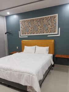Cama ou camas em um quarto em Grand Mulia Hotel Kisaran