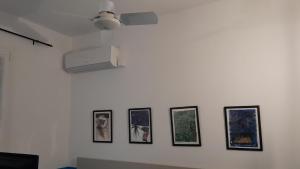 a white wall with four pictures on it at Hotel Villa Argentina in Riomaggiore