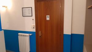 a room with a wooden door and a radiator at Hotel Villa Argentina in Riomaggiore