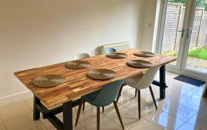 a wooden table with four rocks on top of it at Taplow Stunning Four Bedroom Townhouse in Taplow