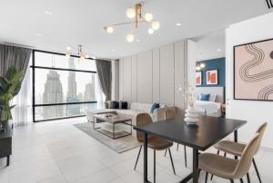 a living room with a dining table and a couch at Silkhaus Index Tower 1BDR with stunning view in DIFC in Dubai