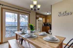 a dining room with a wooden table with chairs at Pool- Pinecrest Townhomes-1King-2Queen Unit-Updated in Pigeon Forge