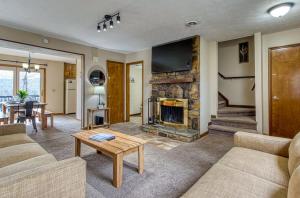 a living room with a couch and a fireplace at Pool- Pinecrest Townhomes-1King-2Queen Unit-Updated in Pigeon Forge